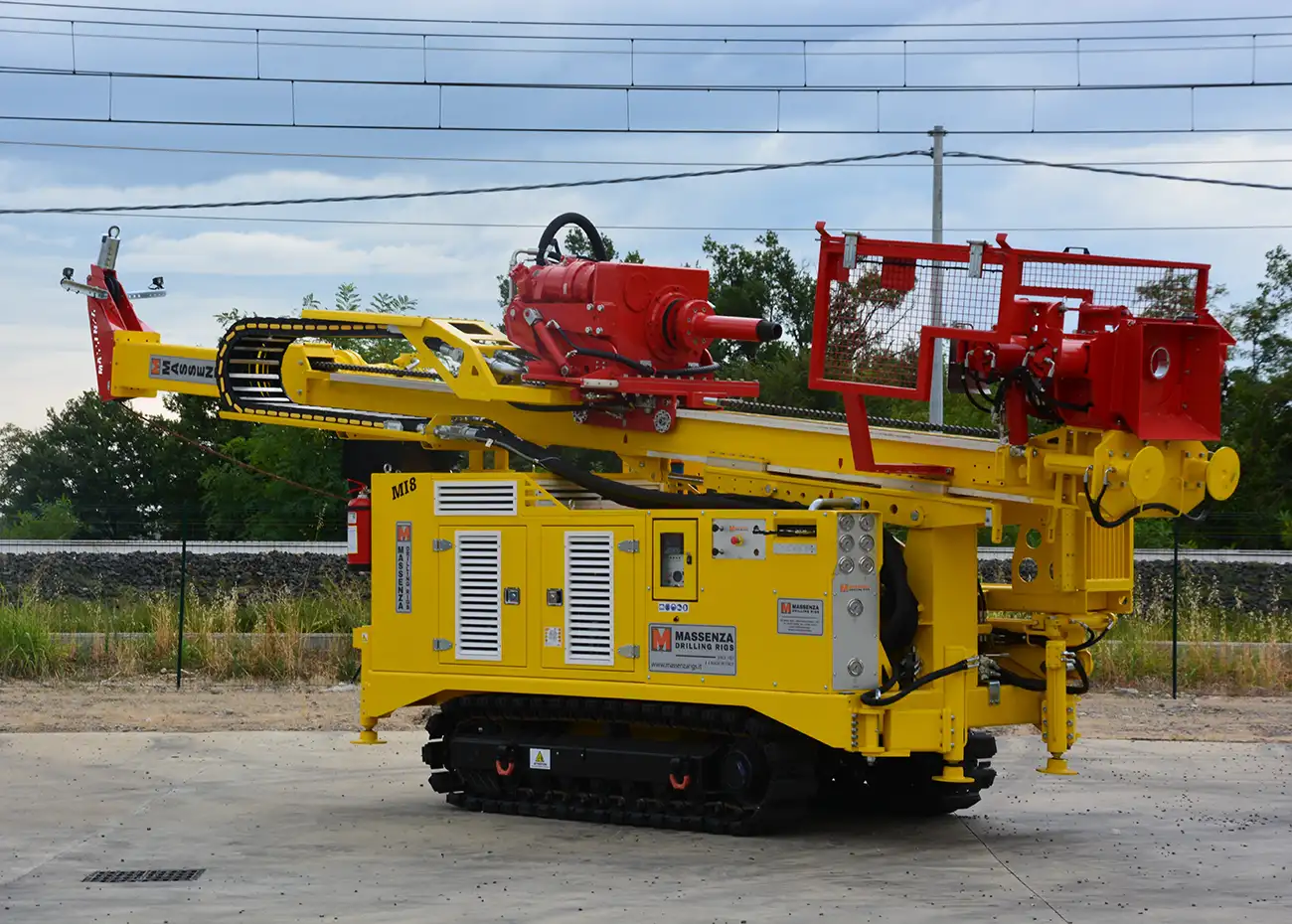 Yellow and red tracked drill rig operated by Split Rock Drilling Inc.