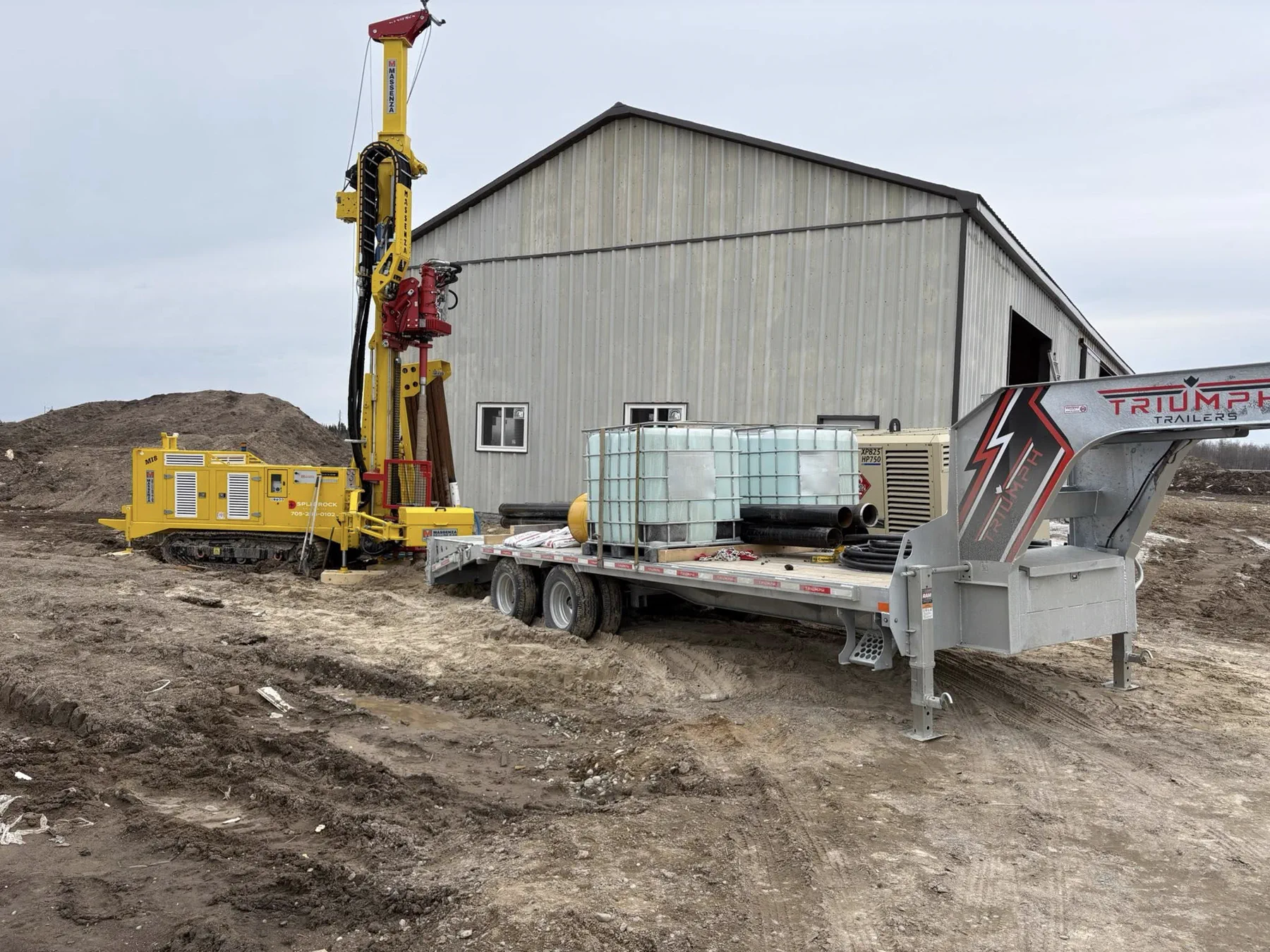 Split Rock Drilling rig and support trailer set up on a field site.